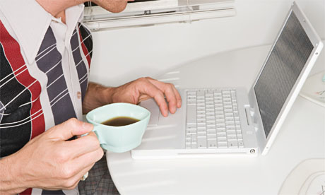 Young man with laptop and coffee